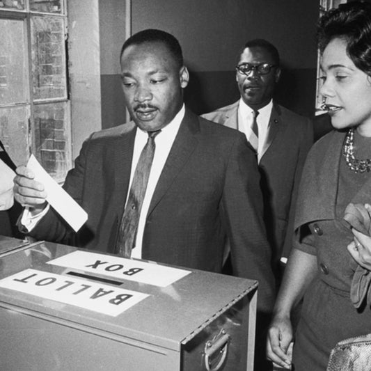 Martin Luther King Jr casting a ballot to vote