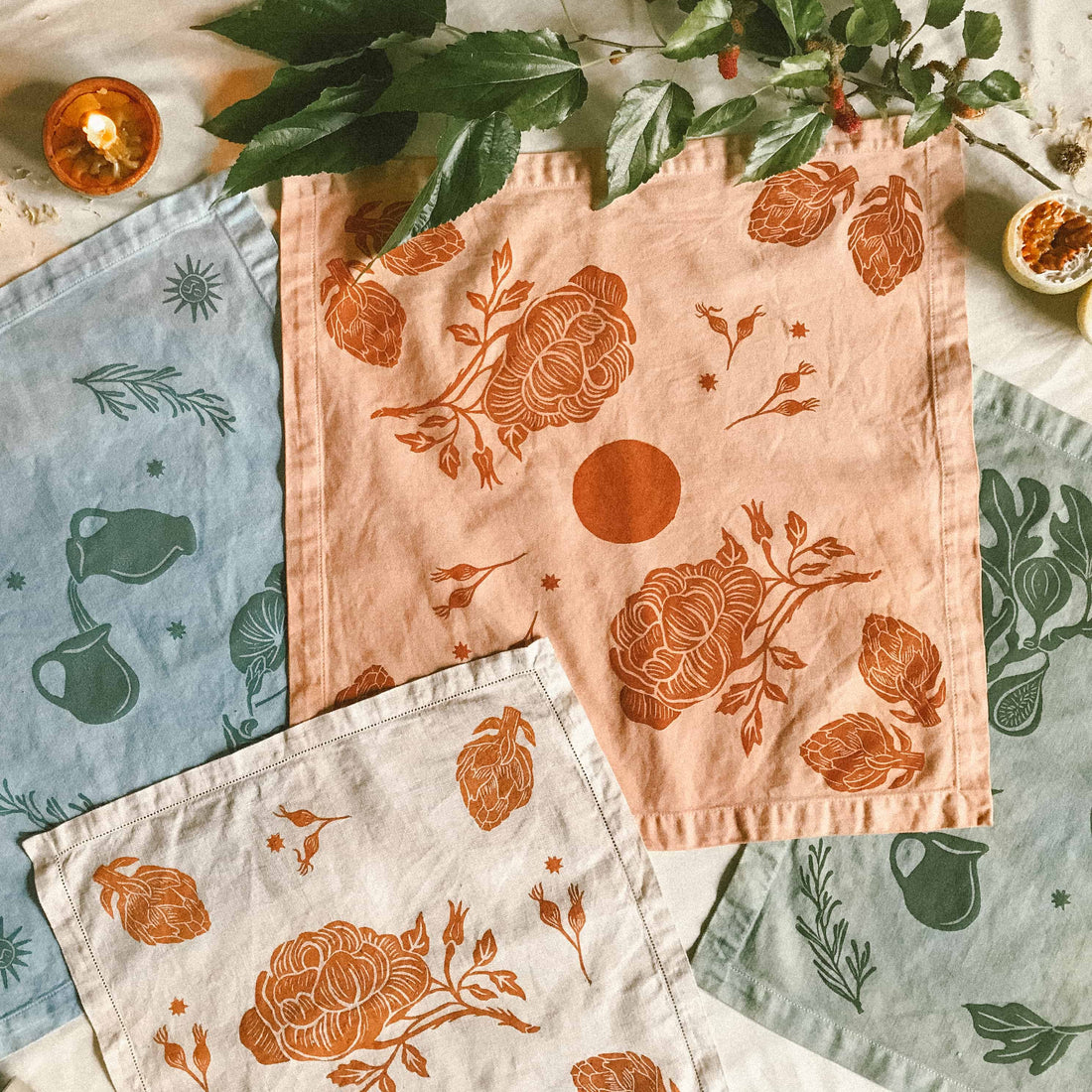 A flat lay of plant dyed and block printed altar cloths made by Hina Luna